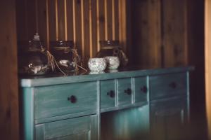 a blue dresser with vases on top of it at Vila Termal in Veľký Meder