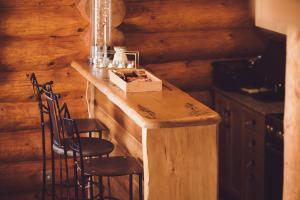 a kitchen with a wooden island in a log cabin at Vila Termal in Veľký Meder