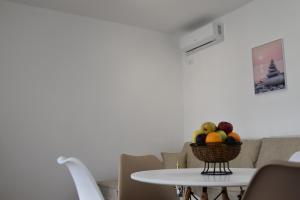 a bowl of fruit on a table in a living room at KenDar Premium Apartments in Ulcinj