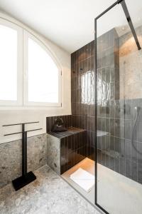 a bathroom with a walk in shower and a sink at Residenza Leutari in Rome