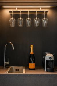 a bottle of wine sitting on a counter next to a sink at Residenza Leutari in Rome