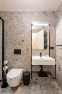 a bathroom with a sink and a toilet and a mirror at Residenza Leutari in Rome