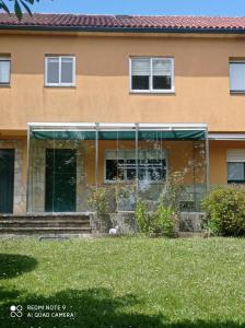 a building with glass windows and a lawn at En el camino in Santiso