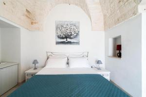 Un pat sau paturi într-o cameră la B&B Villa Vittoria Ostuni