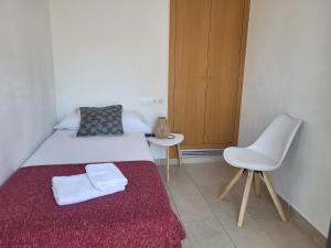 a small bedroom with a bed and a chair at Roses Casc Antic SL Sabater 2 in Roses