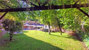 a view of a yard with trees and a building at Locanda Le Panche in Pistoia