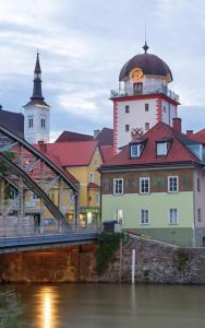 a building with a clock tower next to a bridge at JUGENDSTIL VILLA LEOBEN GÖSS - nahe SPIELBERG FORMEL 1 in Leoben