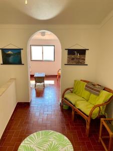 a living room with a yellow couch and a table at Casa David in Castelo de Vide