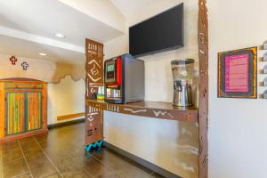 a room with a counter with a tv on a wall at Best Western Plus Rio Grande Inn in Albuquerque