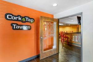 an orange wall with a sign for a restaurant at Best Western Plus Rio Grande Inn in Albuquerque