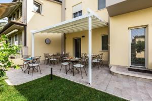 a patio with a table and chairs and a building at Casa Rita in Sabaudia