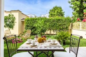 a table with a bowl of fruit on a patio at Casa Rita in Sabaudia