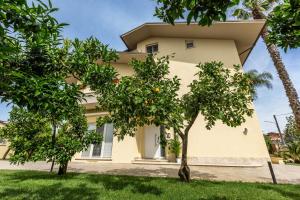 a house with orange trees in front of it at Casa Rita in Sabaudia