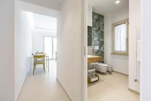 a white hallway with a table in a room at Casa Rita in Sabaudia