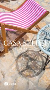 a chair with a red and white striped towel at Casa Selimi in Ulcinj