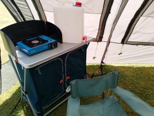 カイユー・シュル・メールにあるtente en baie de somme chez l habitantのテーブル、ラジオ、椅子が備わるテント