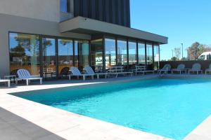 a swimming pool in front of a building at Adonis le Castellet in Signes