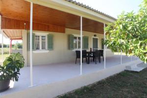 a screened in porch of a house with a table at Olga Home Agios Ioannis Lefkada - Lefkada BnB in Lefkada Town