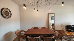 a dining room with a wooden table and chairs at Apartamento com terraços privativos em resort de luxo in Alvor