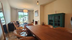 a dining room with a wooden table and chairs at Apartamento com terraços privativos em resort de luxo in Alvor