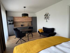 - une chambre avec un lit, une table et des chaises dans l'établissement H52 Apartments, à Brno