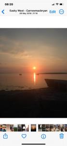 een screenshot van een foto van een zonsondergang over het water bij Seafront House in Sligo