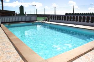 a large swimming pool with blue water at Corralejo Lodge in Corralejo