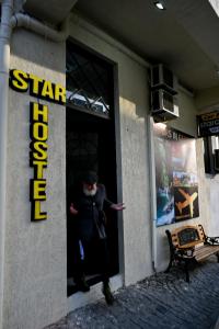 una mujer parada en la puerta de un edificio en StarHostel, en Kutaisi