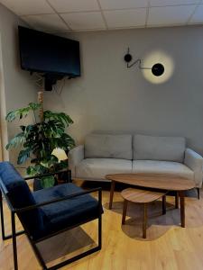 a living room with a couch and a table at Kyriad Deauville - St Arnoult in Deauville