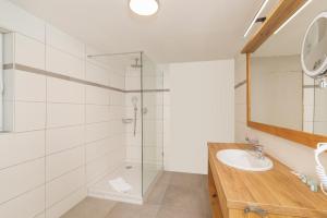 a bathroom with a glass shower and a sink at Luxus-Appartement mit Whirlpool und Sauna #531 in Ainring