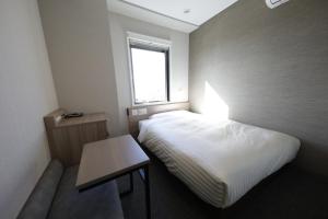 Llit o llits en una habitació de Super Hotel Sano Fujioka