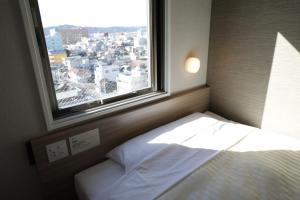 Llit o llits en una habitació de Super Hotel Sano Fujioka