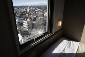 Llit o llits en una habitació de Super Hotel Sano Fujioka