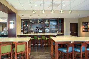 a bar in a restaurant with wooden tables and chairs at Hyatt Place Washington DC/US Capitol in Washington