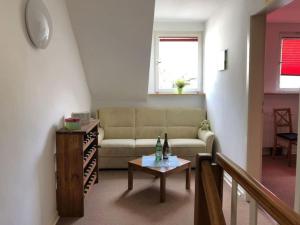 a living room with a couch and a table at Ferienhaus Schwanennest in Zell an der Mosel