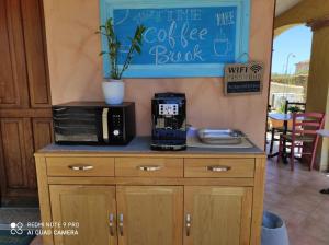 a counter with a coffee maker on top of it at Nora Guesthouse Rooms and Villas in Pula