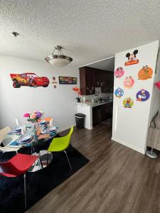 a dining room with a table and a refrigerator with stickers on it at Mario, Harry Potter & Disney Loft Universal Studios 10min loft apartment in Los Angeles