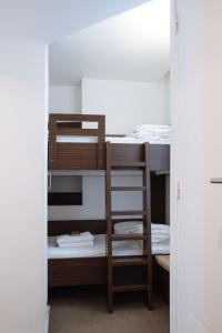 a bunk bed with a ladder in a room at Hôtel & Appartements Monsigny in Nice