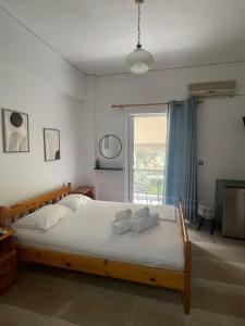 1 dormitorio con 1 cama con 2 toallas en Sunshine Apartments and Rooms, en Nikiana