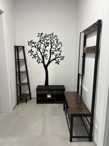 a room with a mirror and a tree on the wall at CityLife InApartment Salzburg in Salzburg