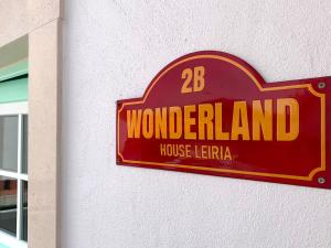 ein Zeichen für ein Wunderland Haus Iettra an einer Wand in der Unterkunft Wonderland House Leiria in Leiria