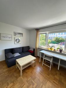 a living room with a couch and a table at Double Bed Apartment - Near Marienplatz in Stuttgart