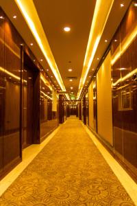 an empty hallway in a building with a carpet at City Park Hotel Apartments in Muscat