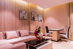 a living room with a couch and a table at City Park Hotel Apartments in Muscat