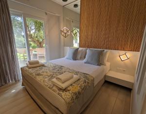 a bedroom with a bed with two pillows on it at Kotroni Villas in Finikounta