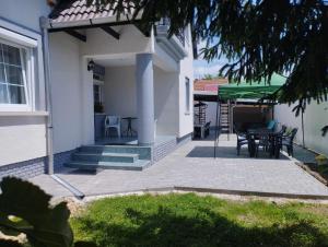 a patio of a house with a table and chairs at Viola Apartmanház in Bogács