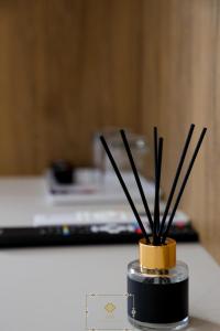 a container with sticks in it sitting on a counter at HM Boutique Hotel in Krujë