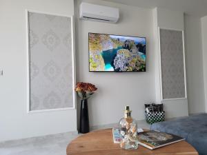 a living room with a tv hanging on a wall at Sea view luxury appartment in Varna City