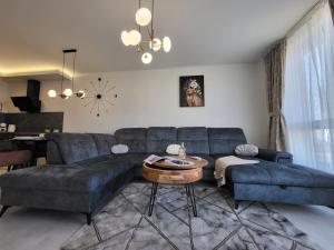 a living room with a blue couch and a table at Sea view luxury appartment in Varna City