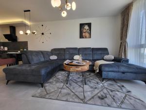 a living room with a blue couch and a table at Sea view luxury appartment in Varna City